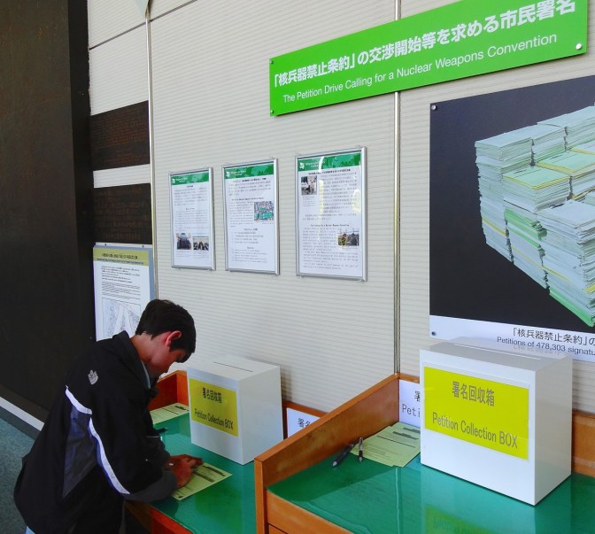 Alex signs a petition asking the nations of the world to outlaw the creation and use of all nuclear weapons.