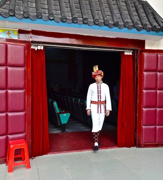 A performer in  Guilin wears his traditional costume just before a performance of local music and dance.