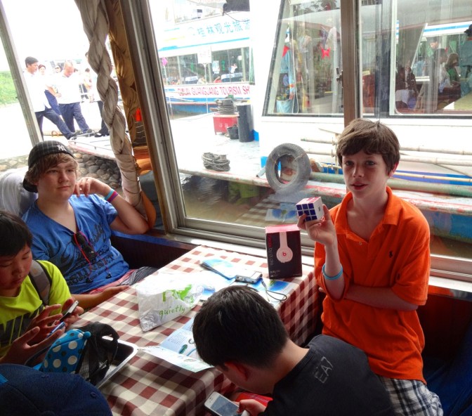 Below deck and just before departure at the marina in Gulin, Alex and his fellow middle schoolers keep busy with rubric cubes, cards and sadly electronics of all sorts.