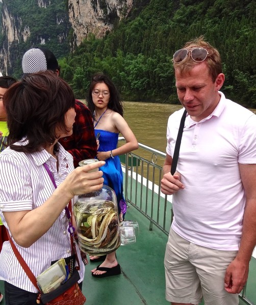 Qingdao teacher, Chris Cronin is less than enthusiastic to the suggestion that he try a glass of the local spirit: Snake wine.