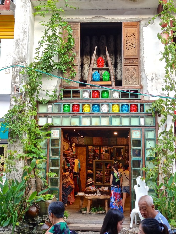 Colorful Buddha heads form a pyramid above the door of this West Street shop in Yangshuo.