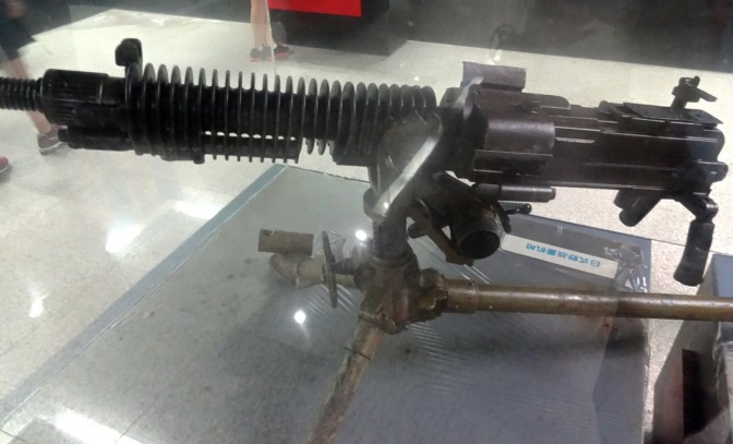 A WWI-era machine gun in a display case at the German Fort Museum in Qingdao.