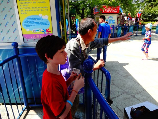 Alex prepares to claim his seat on the Swinging Chairs ride.