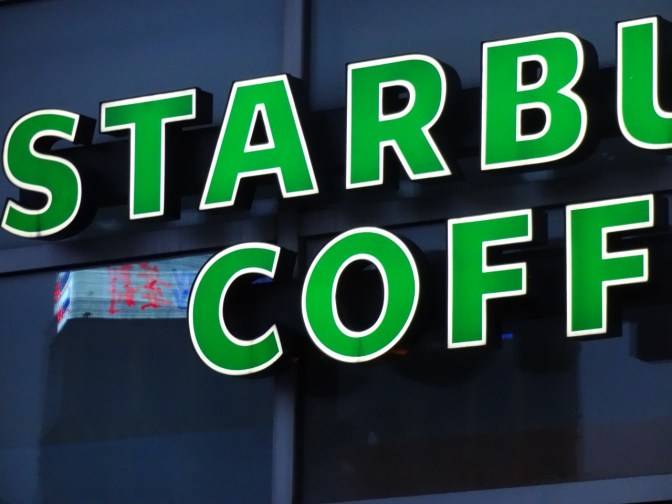 The familiar glow of a Starbucks sign lights up at Marina City. Despite China's preference for tea, many young people now include coffee in their daily routines.