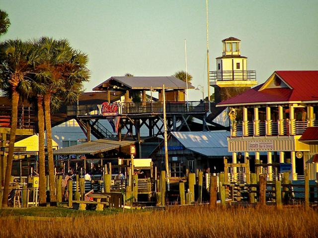 Toward the Coleman Boulevard bridge, a half dozen seafood-themed restaurants, including a faux lighthouse and genuine but converted icehouse. The icehouse operated until a few years back when declining numbers of shrimp boats needed less ice to fill their holds to protect the shrimp and seafood within. Red's Icehouse serves only ice in drinks these days.