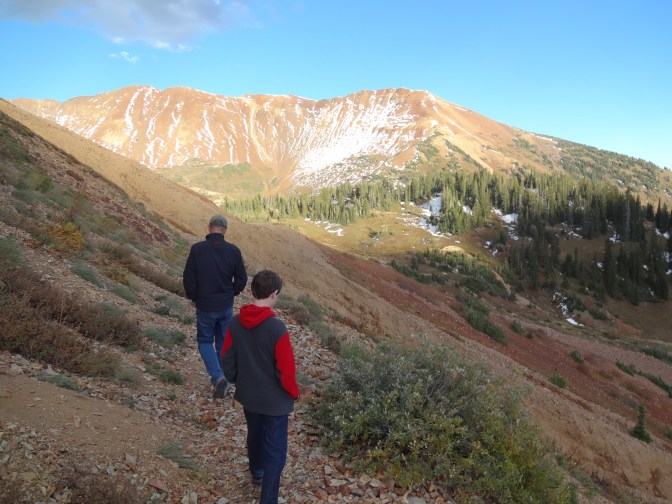 Alex and John, an old high school pal, and full-time CB resident  hike near Gothic Mountain through snow patches and remnants trails recently blown down the mountainside by torrents of unusual September rainstorms.